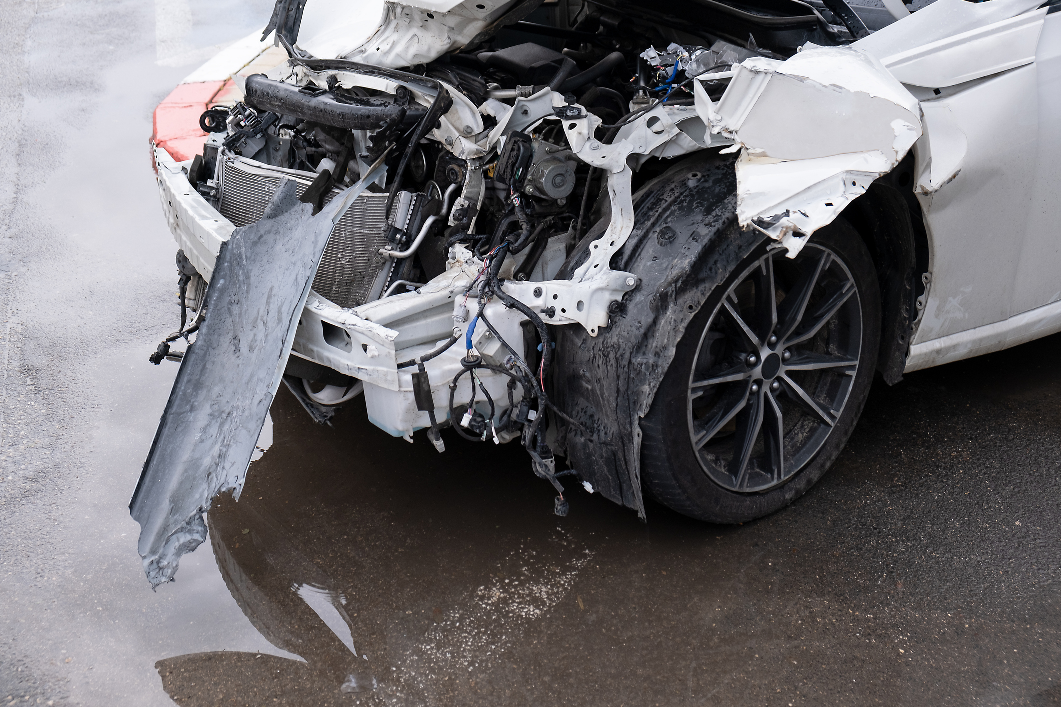 Dented Car front bumper and light lamp. Crashed metall on private car. Car insurance Transport concept. Auto Accident Injury in Stuart, FL