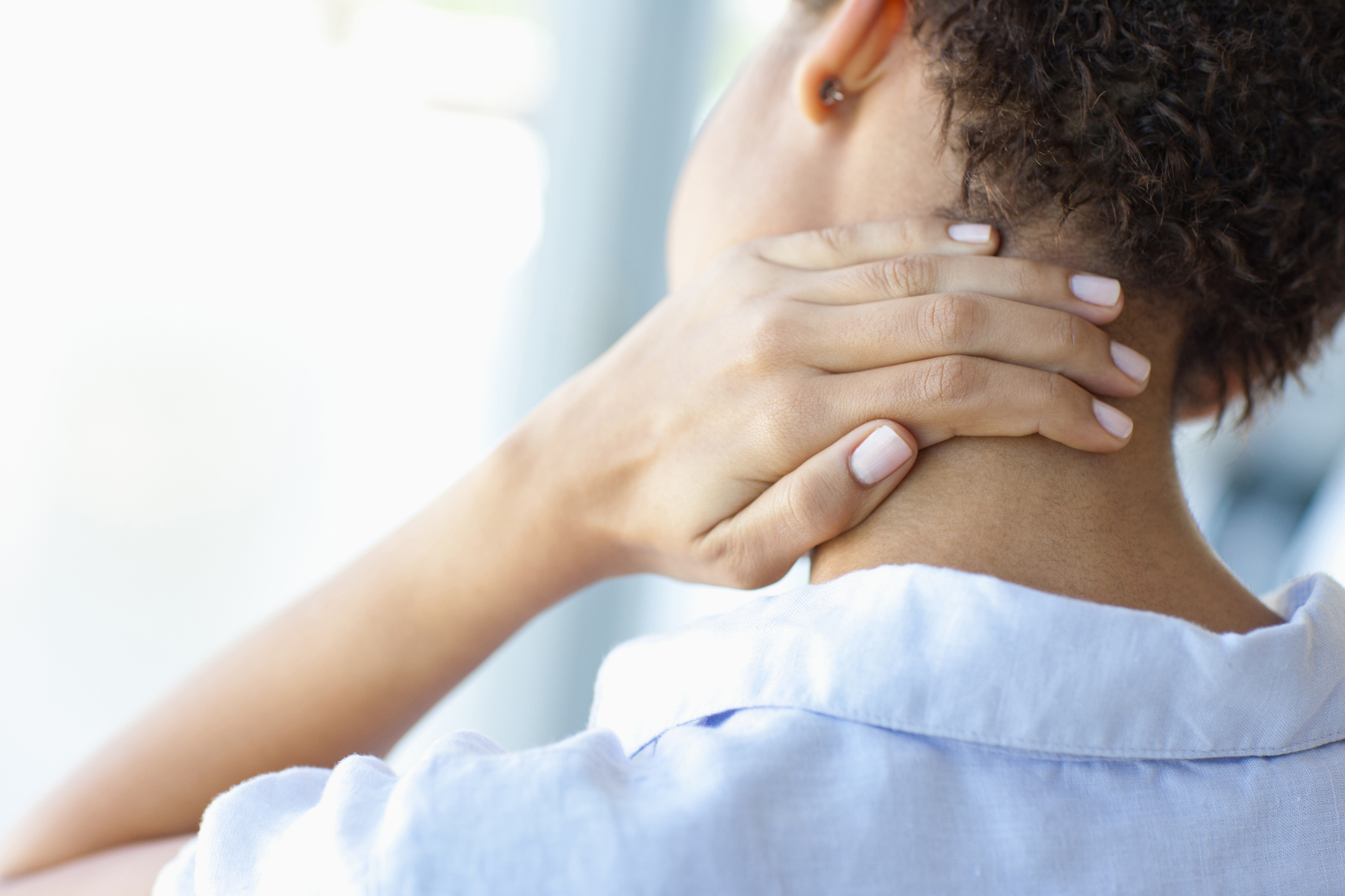 Woman rubbing sore neck acute pain relief